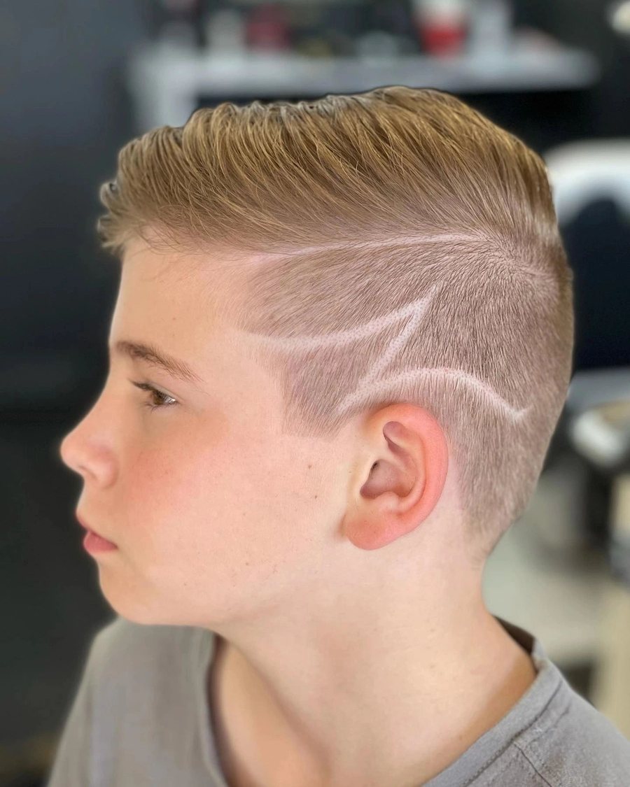 Side profile of a boy with a lightning bolt design shaved into a skin fade.